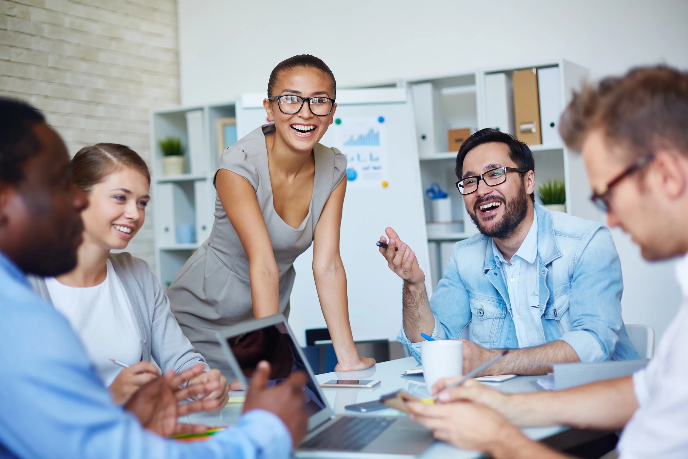 Diverse professional team collaborating in a modern office meeting room.
